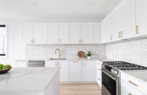 A,Beautiful,Kitchen,Detail,With,White,Cabinets,,A,Gold,Faucet,
